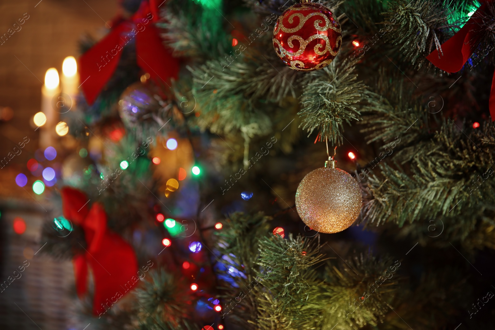 Photo of Christmas tree with beautiful decorations indoors, closeup. Stylish interior element