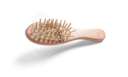 Photo of Brush with lost hair in air on white background