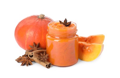 Jar of pumpkin jam, star anise, fresh pumpkin and cinnamon on white background