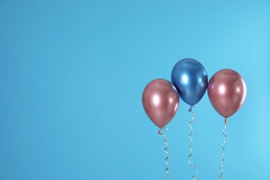 Photo of Bright balloons on color background. Space for text