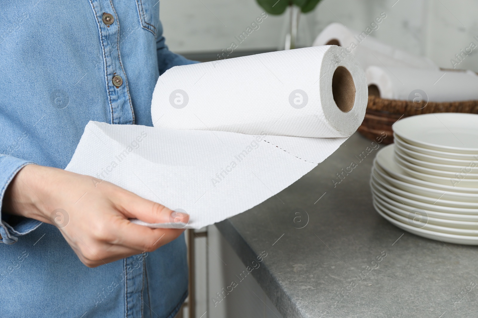 Photo of Woman using paper towels in kitchen, closeup