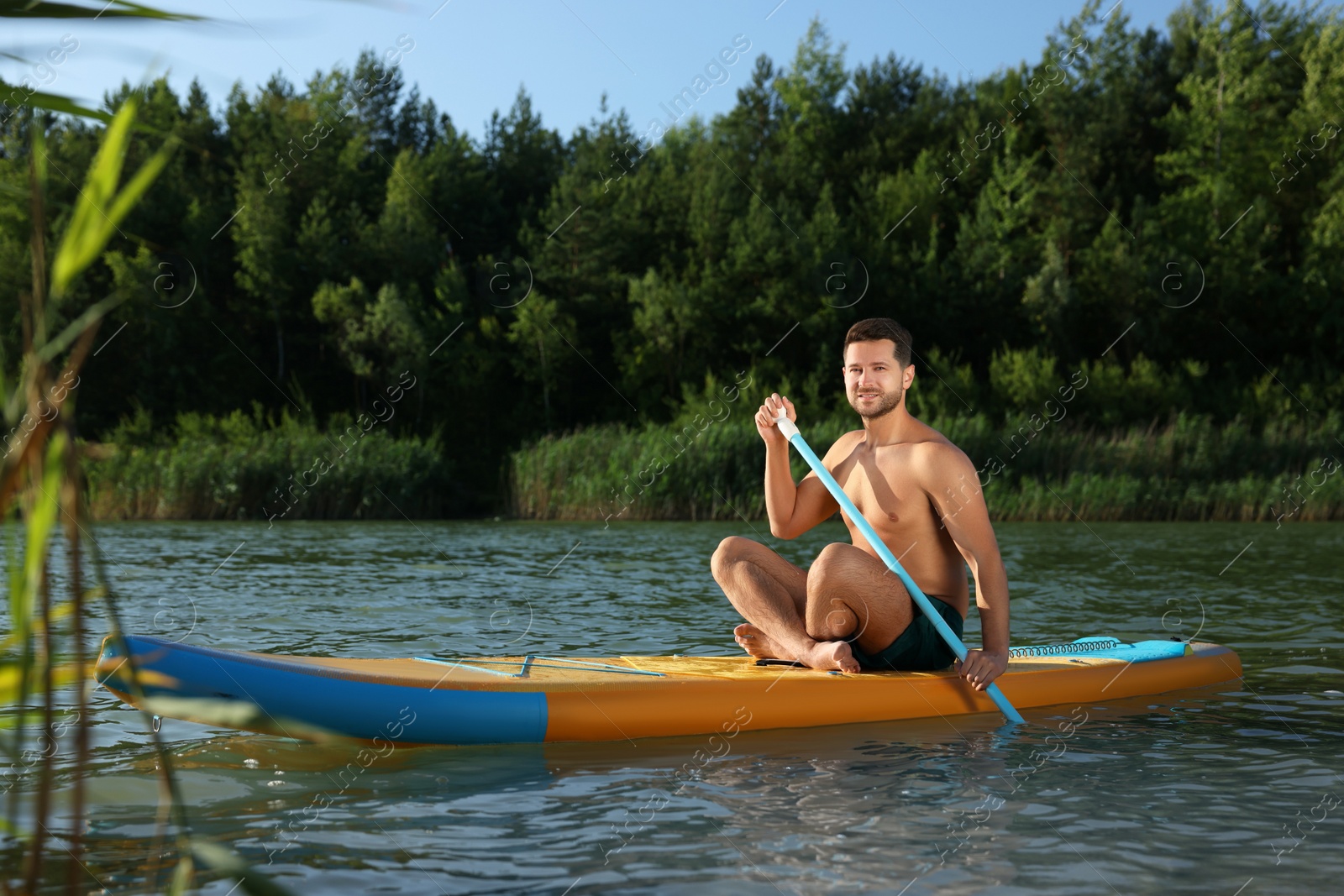 Photo of Man paddle boarding on SUP board in river