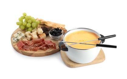 Photo of Fondue with tasty melted cheese, forks and different snacks isolated on white