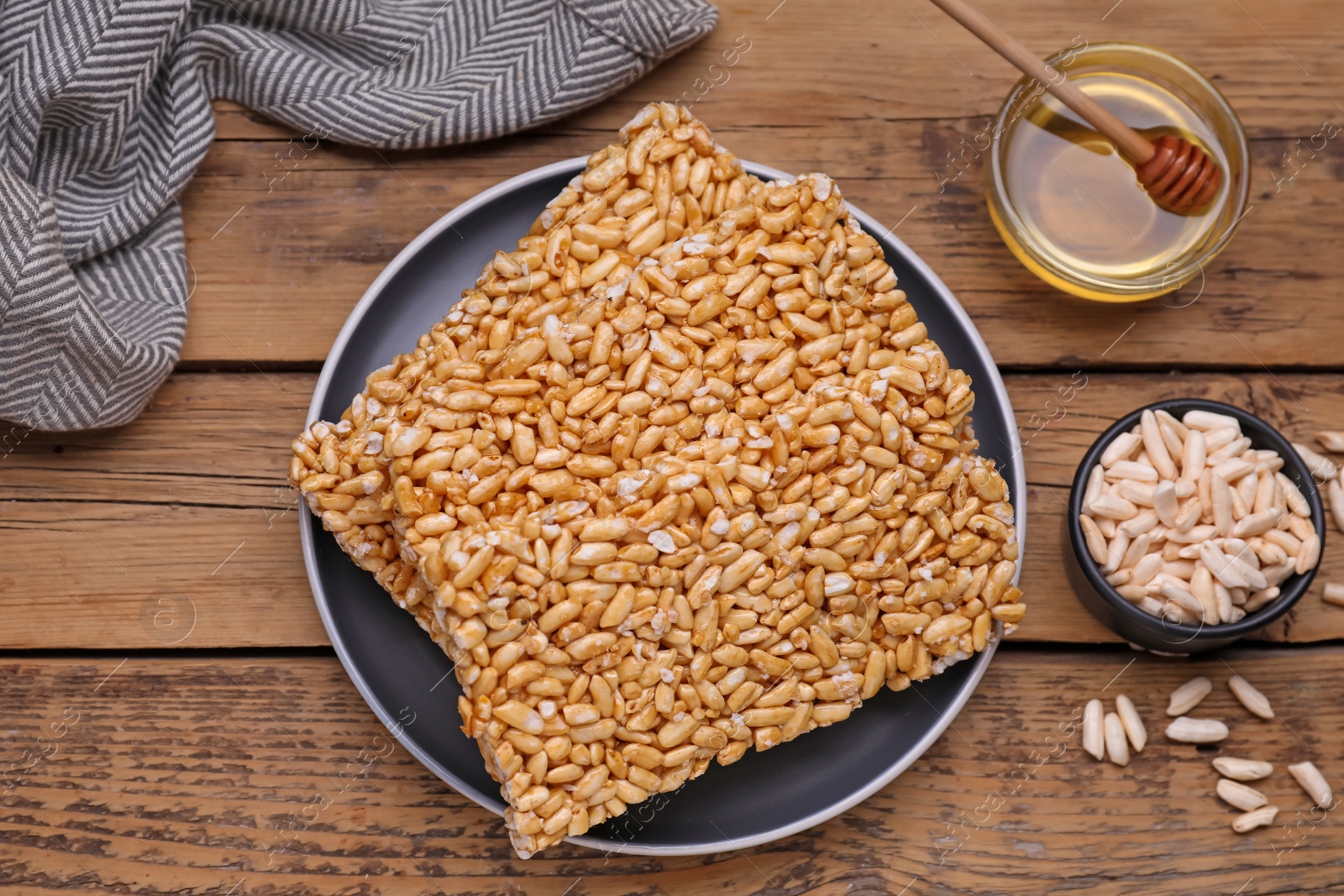 Photo of Puffed rice bars (kozinaki) on wooden table, flat lay