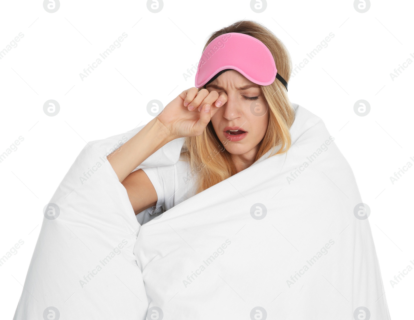 Photo of Tired woman in sleeping mask wrapped with soft blanket on white background