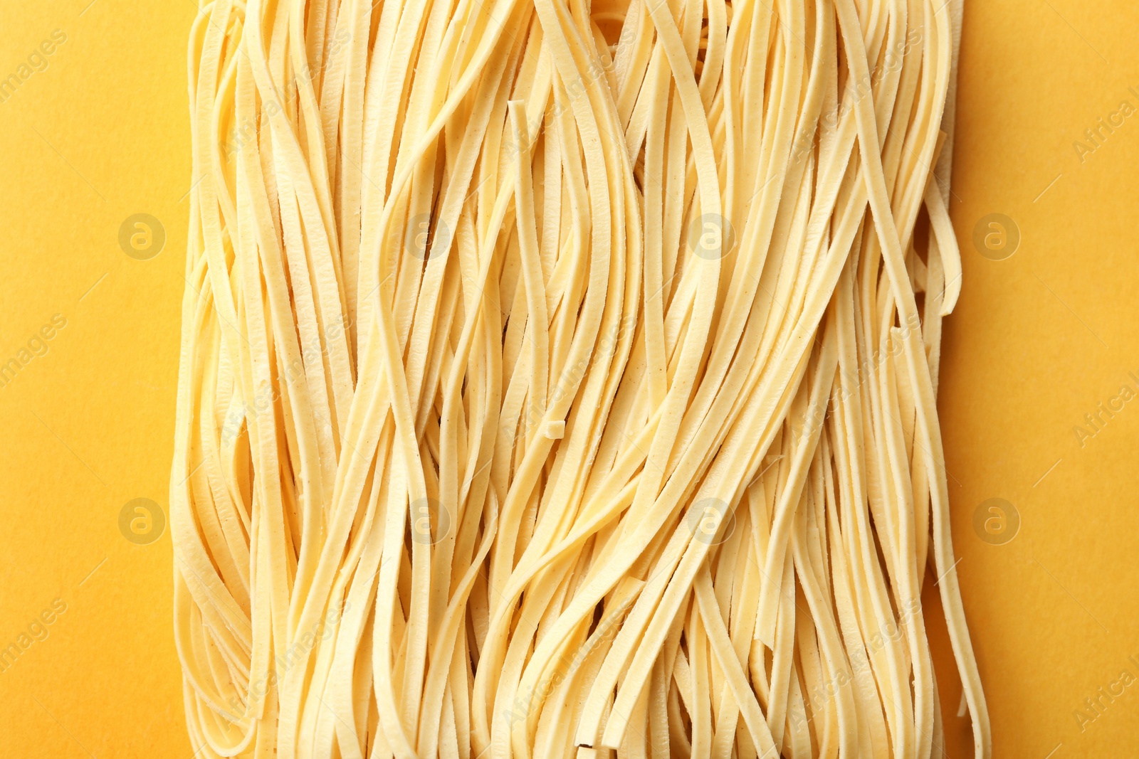 Photo of Block of quick cooking noodles on color background, top view