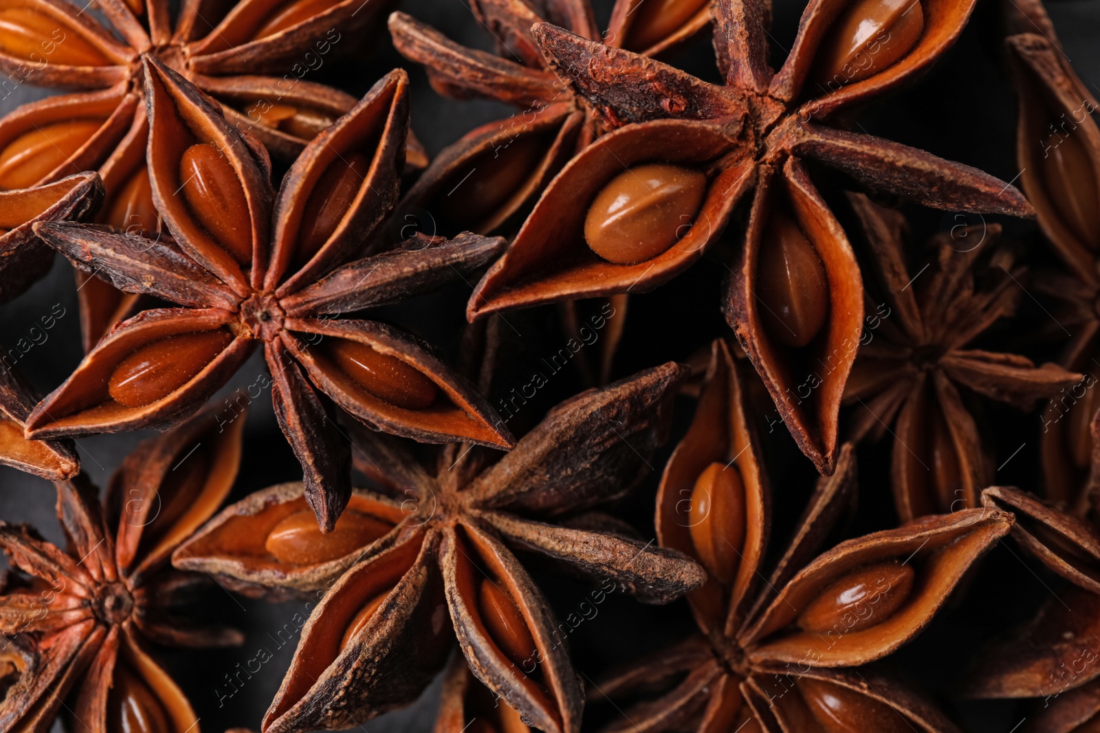 Photo of Aromatic anise stars as background, top view