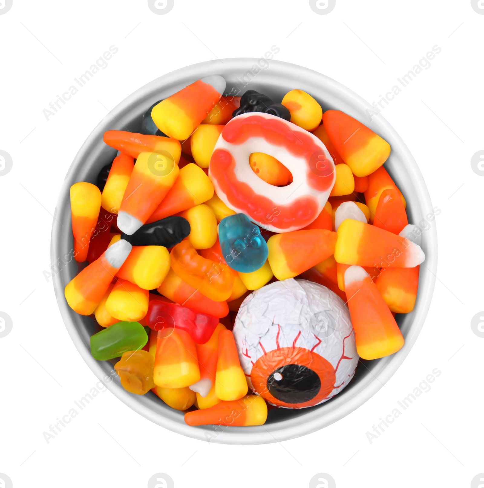 Photo of Bowl of delicious colorful candies isolated on white, top view. Halloween sweets