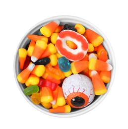 Bowl of delicious colorful candies isolated on white, top view. Halloween sweets