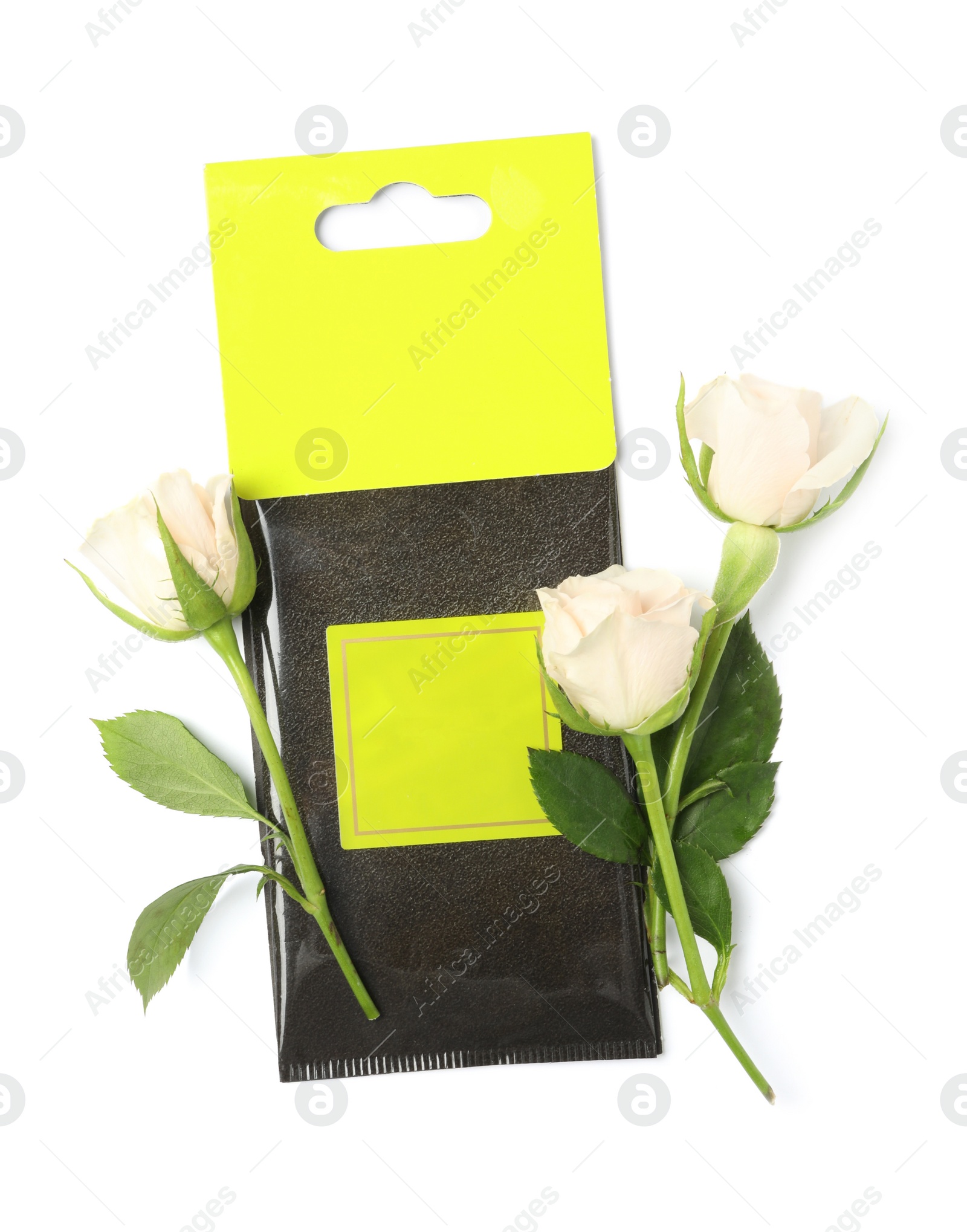 Photo of Scented sachet and roses on white background, top view