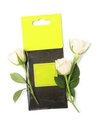 Scented sachet and roses on white background, top view
