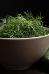 Photo of Bowl of fresh dill on table, closeup