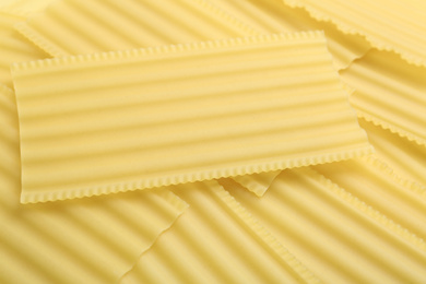 Photo of Pile of uncooked lasagna sheets as background, closeup