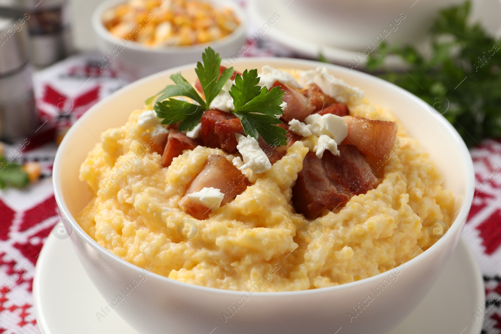 Photo of Delicious traditional Ukrainian banosh in bowl on table, closeup