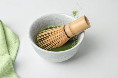 Photo of Chawan with fresh matcha tea and chasen on table