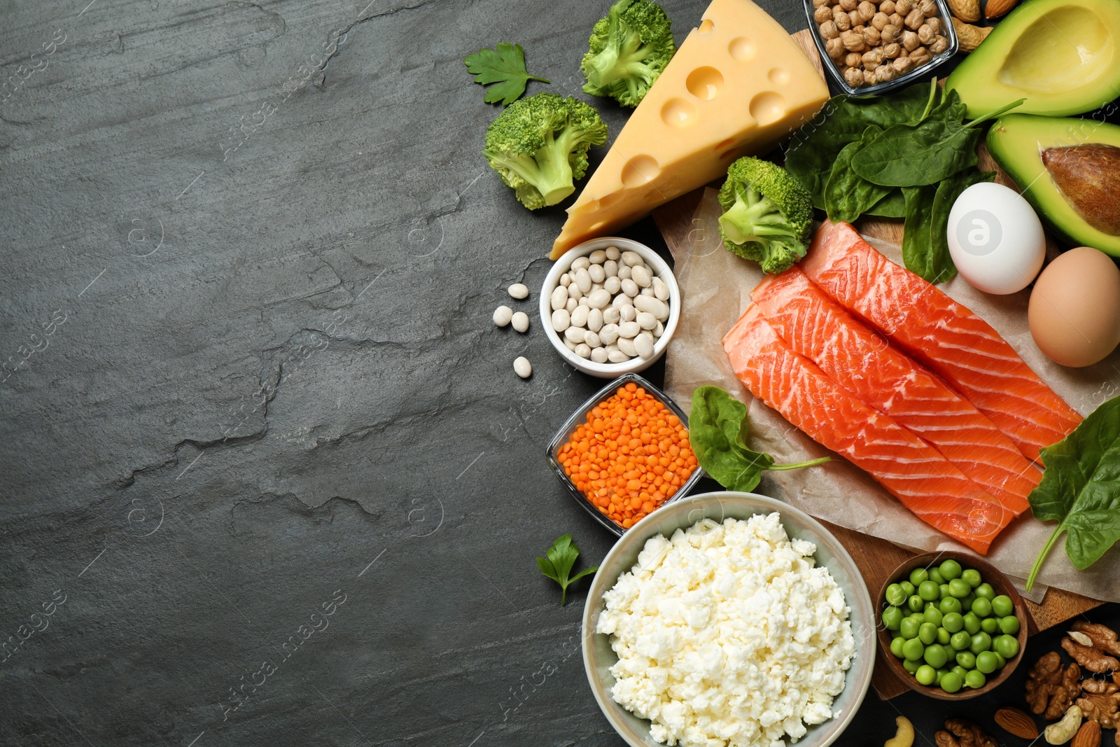 Photo of Products rich in protein on black table, flat lay. Space for text