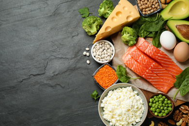 Photo of Products rich in protein on black table, flat lay. Space for text