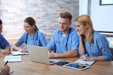 Photo of Medical students in uniforms studying at university