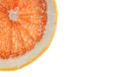 Slice of grapefruit in sparkling water on white background, closeup. Citrus soda
