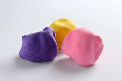 Different color play dough on white background