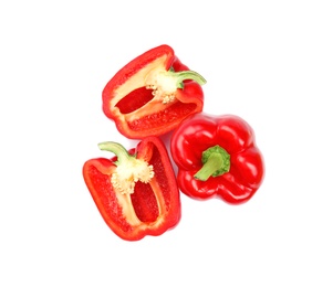 Whole and cut red bell peppers on white background, top view