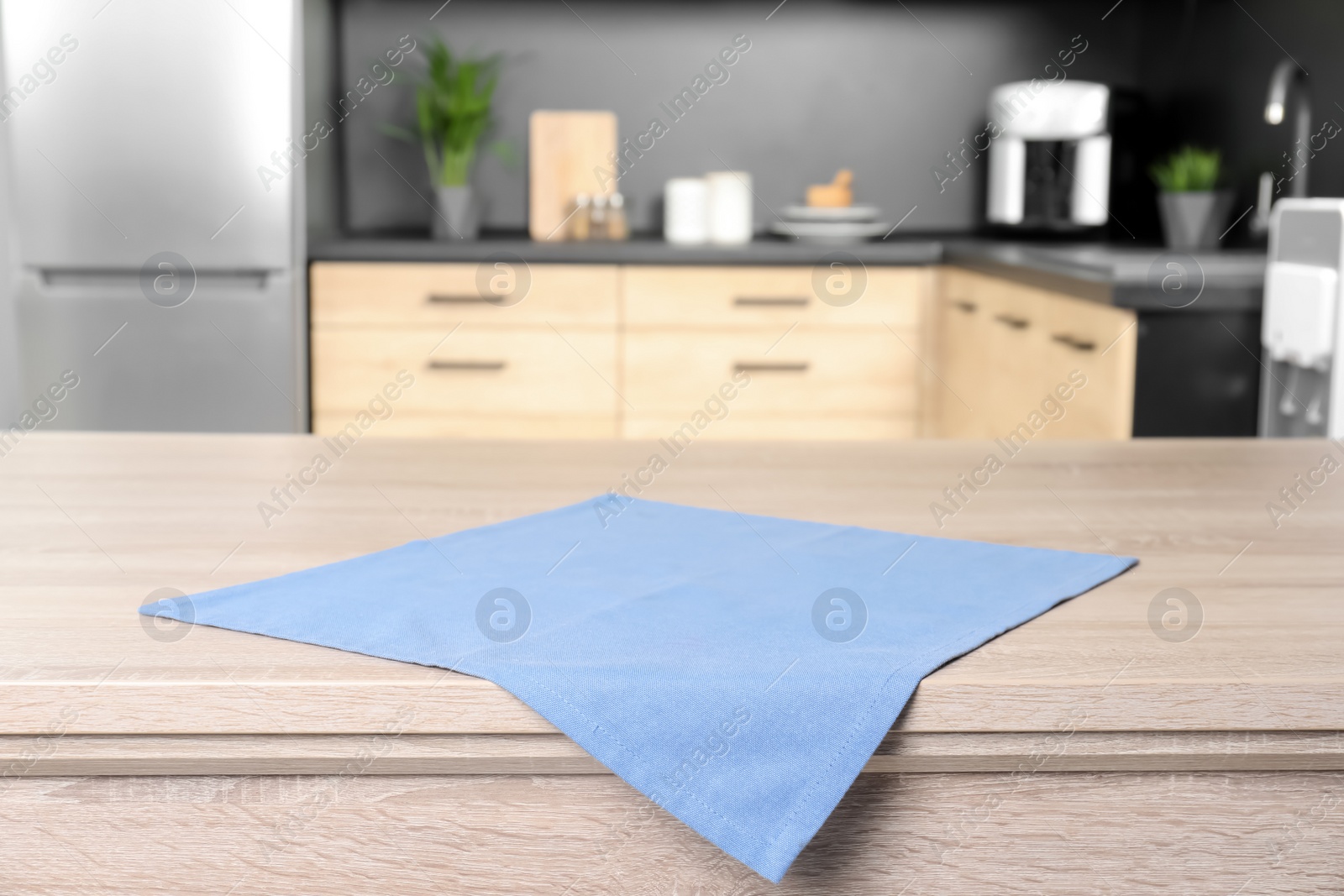 Photo of Napkin on wooden table in kitchen. Mockup for design