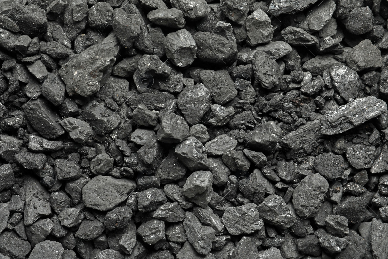 Photo of Heap of coal as background, top view