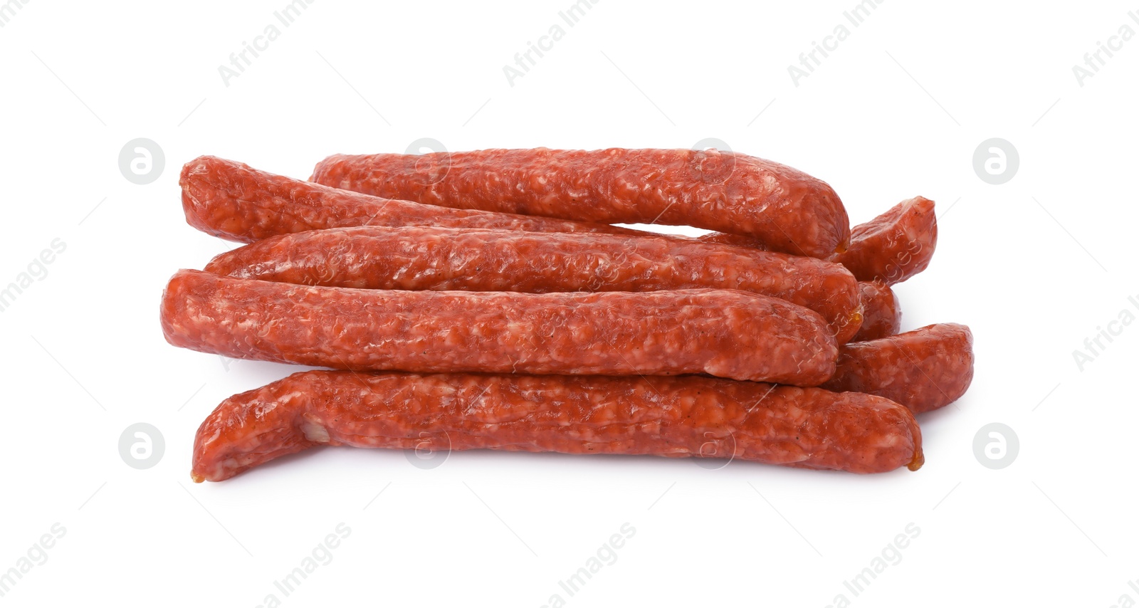 Photo of Many thin dry smoked sausages isolated on white