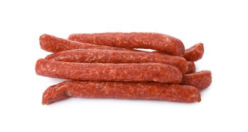 Many thin dry smoked sausages isolated on white