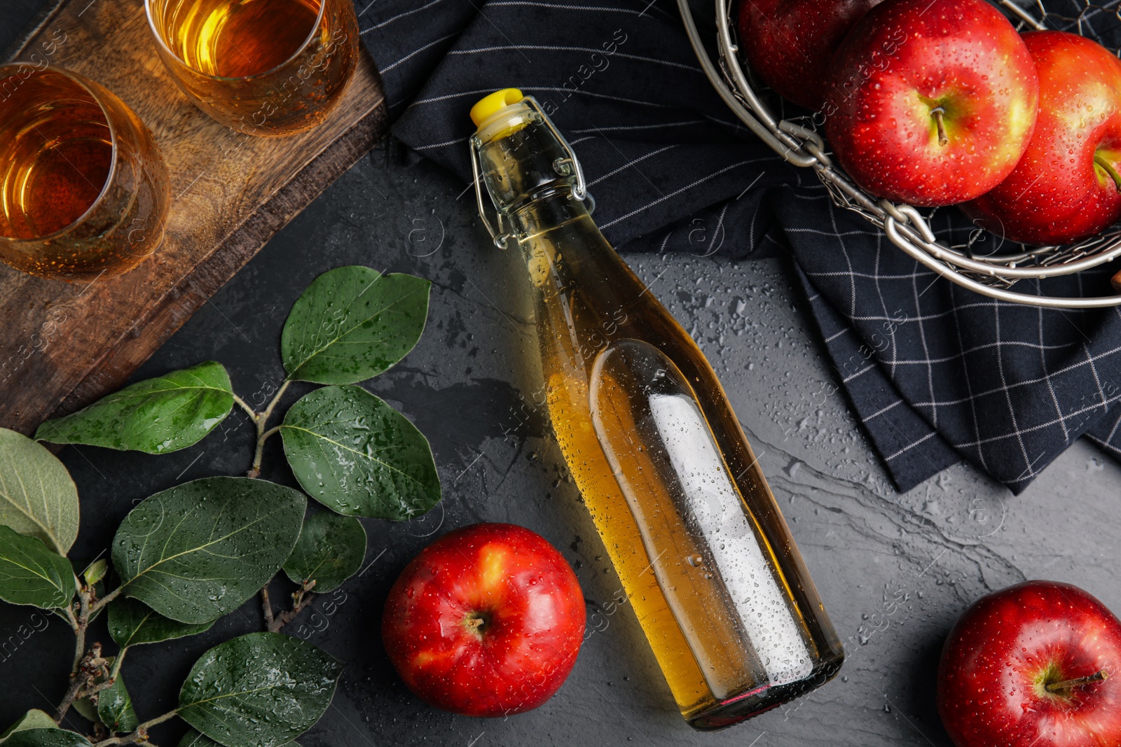 Photo of Flat lay composition with delicious apple cider on black table