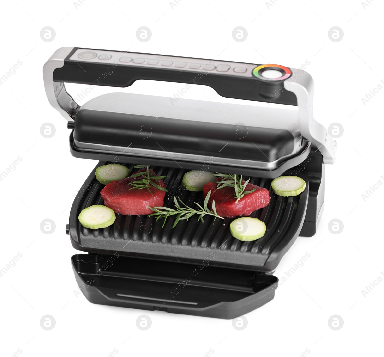 Photo of Electric grill with raw meat, zucchini and rosemary isolated on white