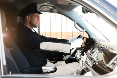 Photo of Professional driver in luxury car. Chauffeur service