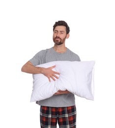 Photo of Sleepy handsome man with soft pillow on white background