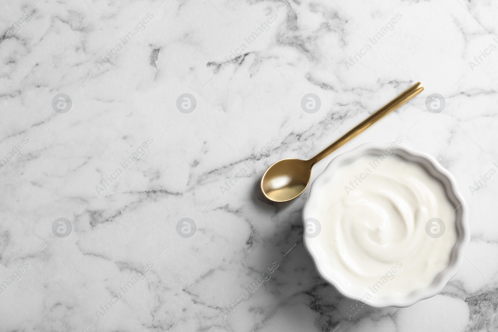 Photo of Bowl with yogurt on table