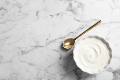 Photo of Bowl with yogurt on table