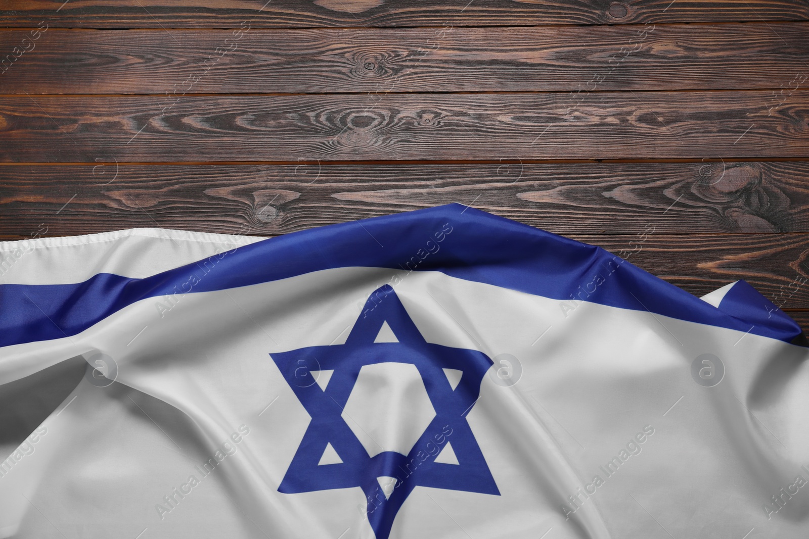 Photo of Flag of Israel on wooden background, top view and space for text. National symbol