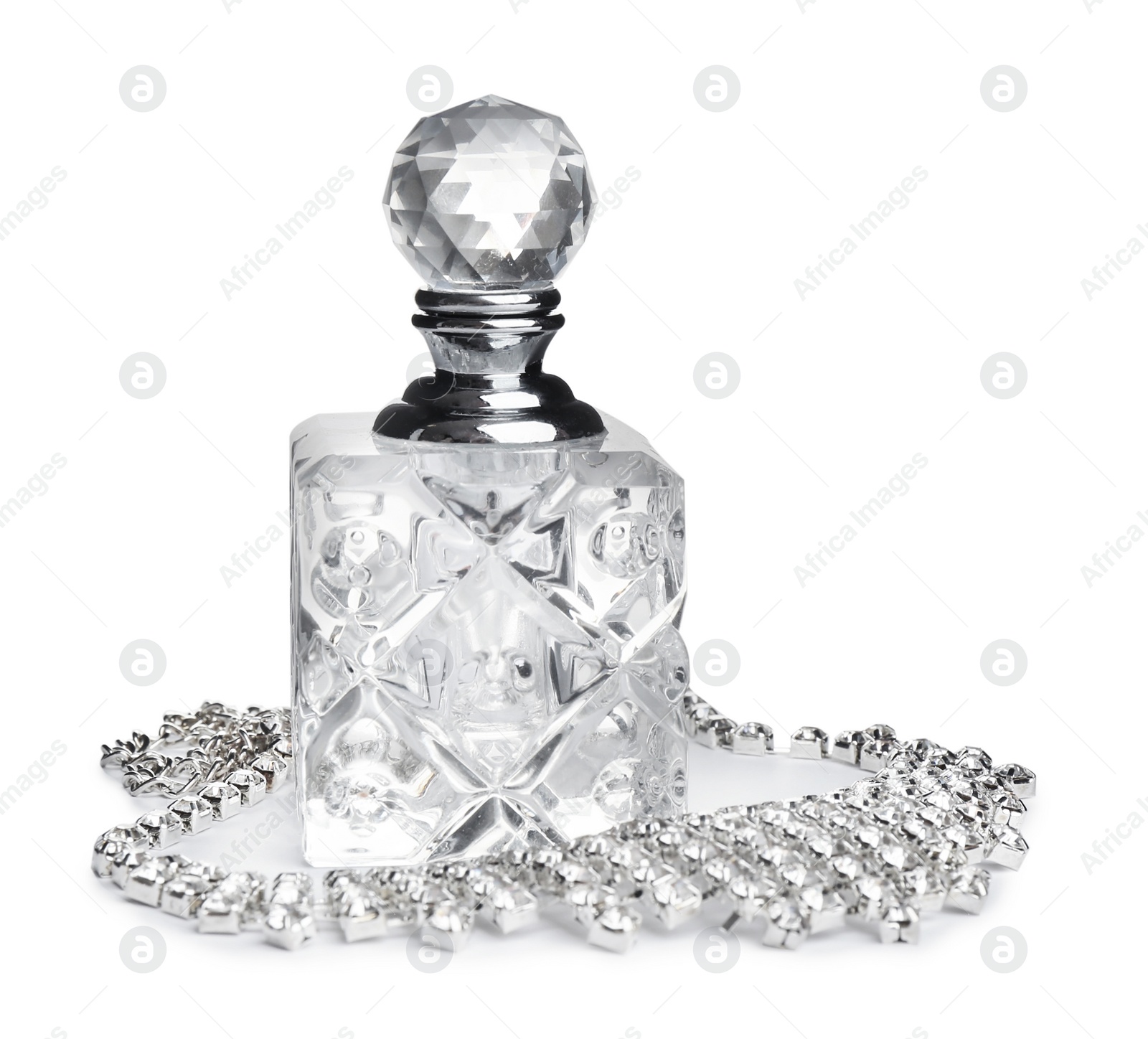 Photo of Glass bottle of perfume and luxury jewellery isolated on white