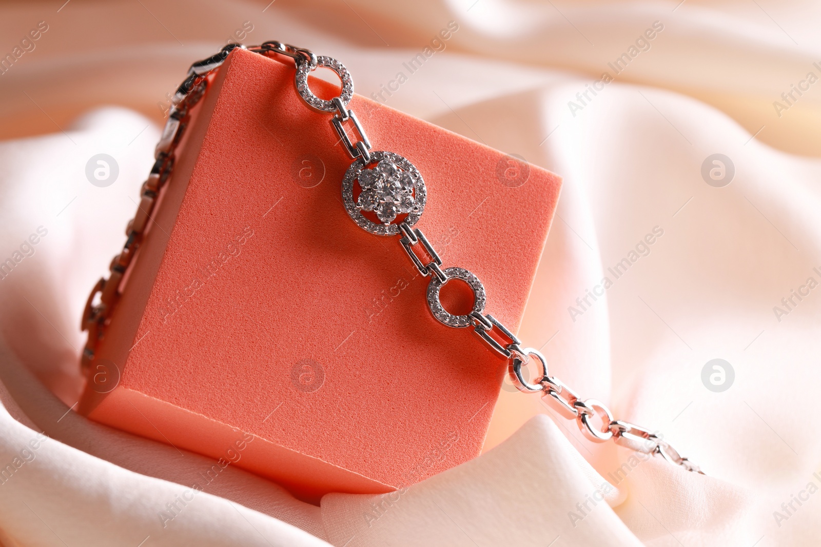 Photo of Elegant jewelry. Stylish presentation of luxury bracelet on podium, closeup