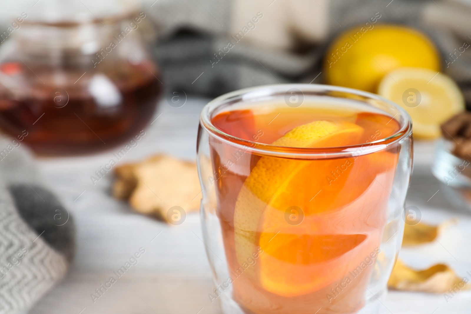 Photo of Cup of hot drink on white wooden table, closeup. Cozy autumn atmosphere