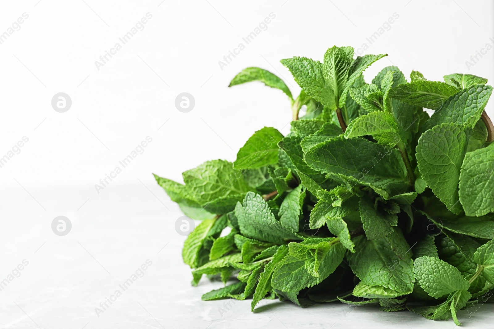 Photo of Bunch of fresh green mint on table, closeup. Space for text