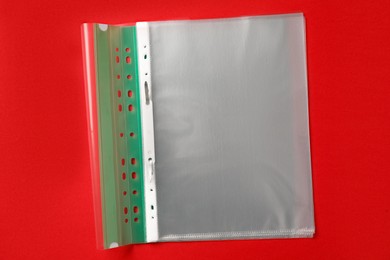 Photo of File folder with punched pockets on red background, top view