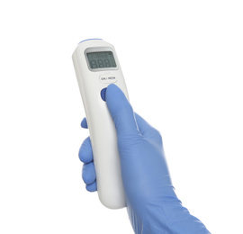 Doctor in latex gloves holding non contact infrared thermometer on white background, closeup. Measuring temperature