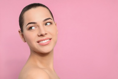 Portrait of young woman with beautiful face and natural makeup on color background, space for text