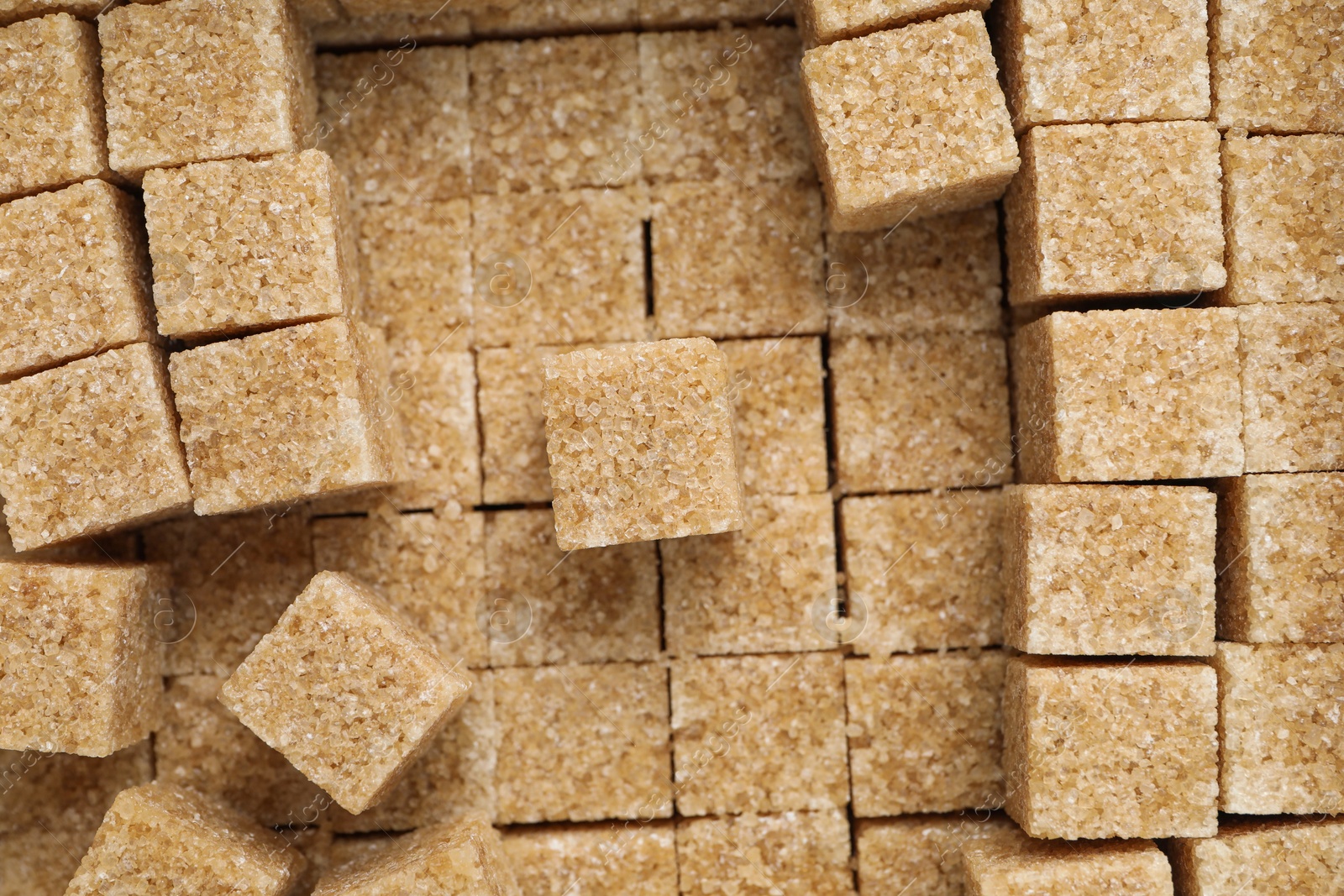 Photo of Brown sugar cubes as background, closeup view