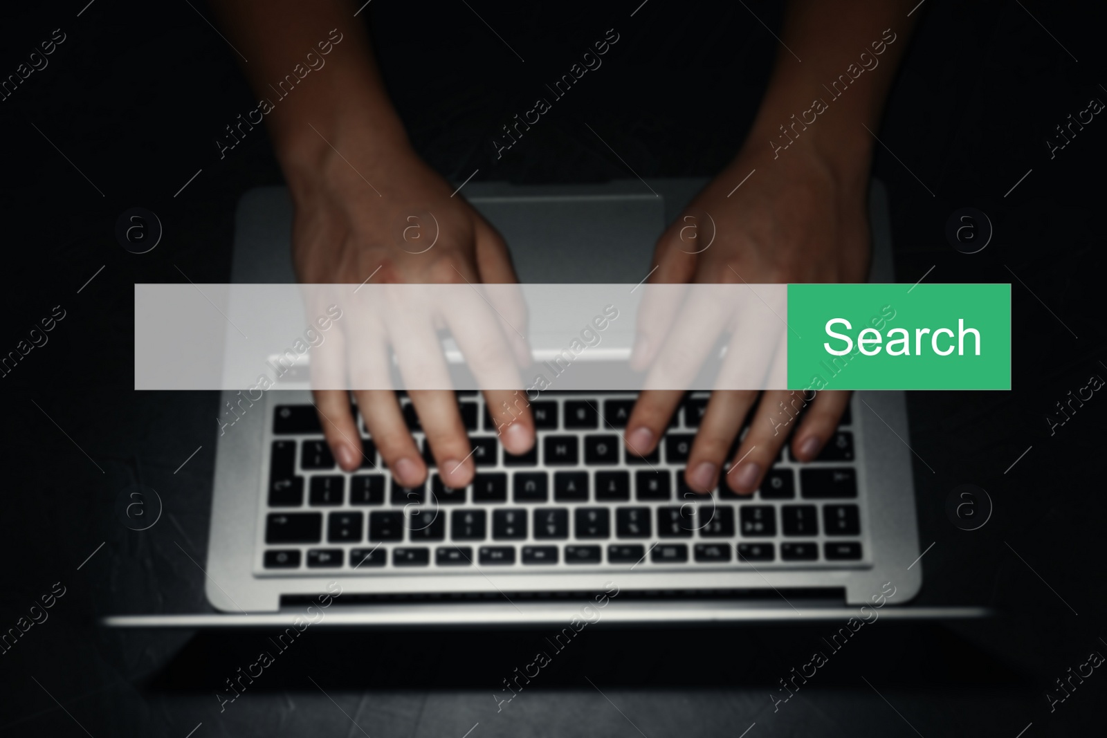 Image of Search bar of internet browser and man working with laptop in darkness, top view
