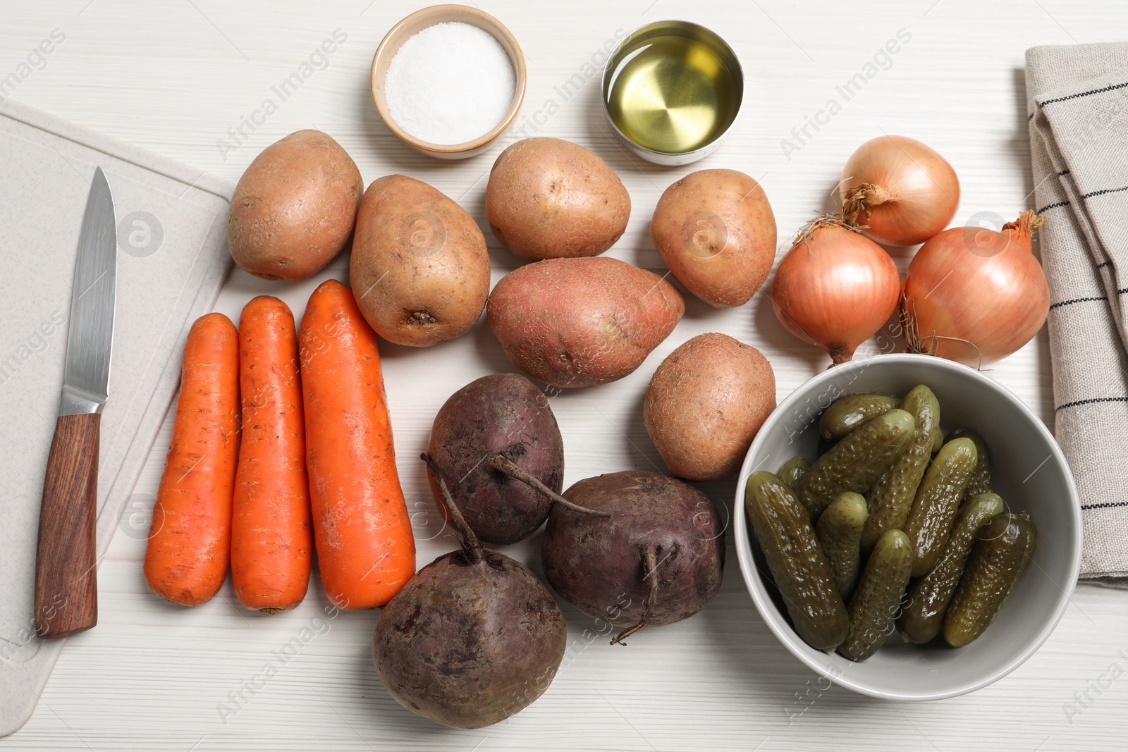 Photo of Many fresh vegetables and ingredients on white wooden table, flat lay. Cooking vinaigrette salad