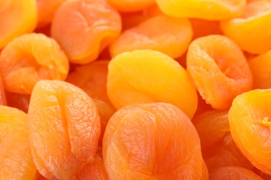 Tasty apricots as background, closeup. Dried fruit as healthy food