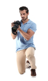 Young photographer with professional camera on white background