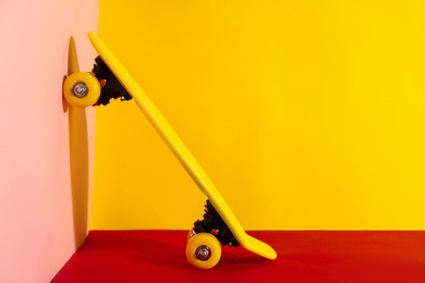 Photo of Yellow skateboard on color background. Space for text