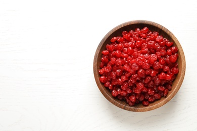 Photo of Bowl of tasty cherries on wooden background, top view with space for text. Dried fruits as healthy food